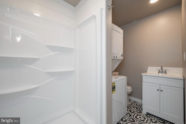 bathroom featuring vanity, toilet, walk in shower, and tile patterned flooring