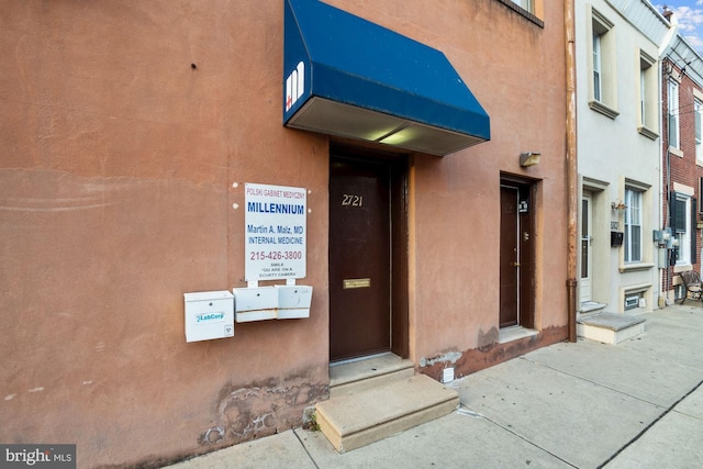 doorway to property with stucco siding