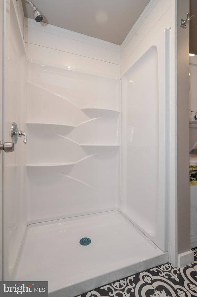 full bathroom with a stall shower and crown molding