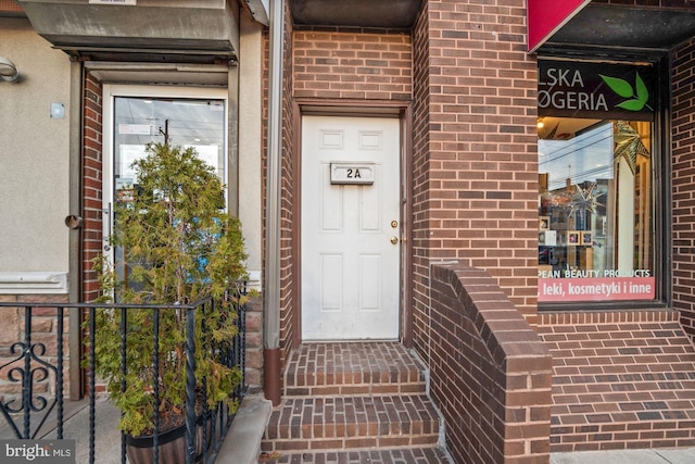 property entrance with brick siding