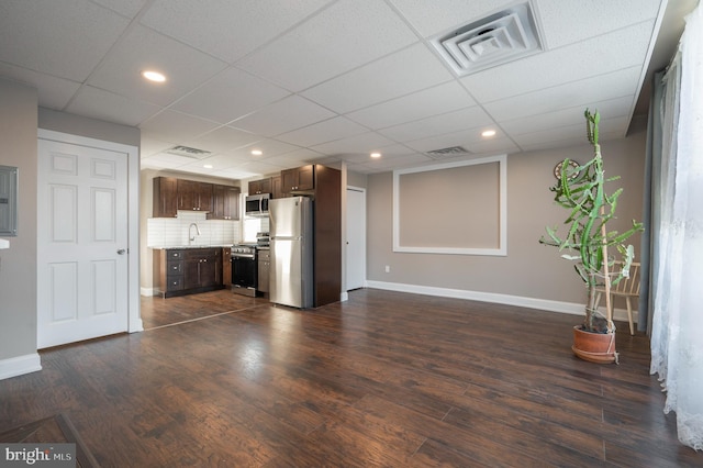 unfurnished living room with sink, dark hardwood / wood-style flooring, and a drop ceiling