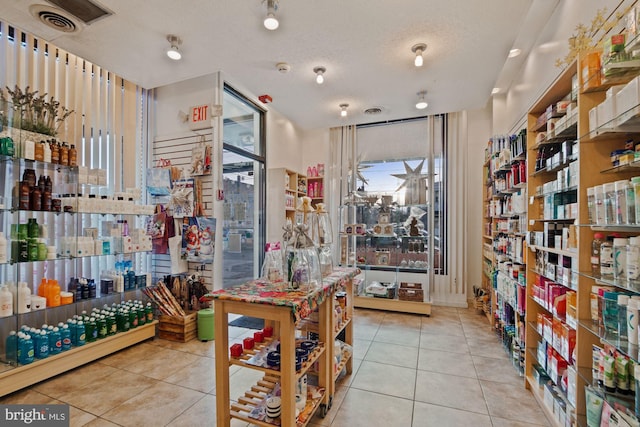 interior space featuring light tile patterned floors and a textured ceiling