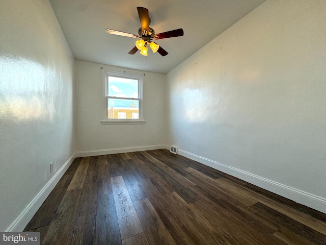 empty room featuring dark wood-type flooring and ceiling fan