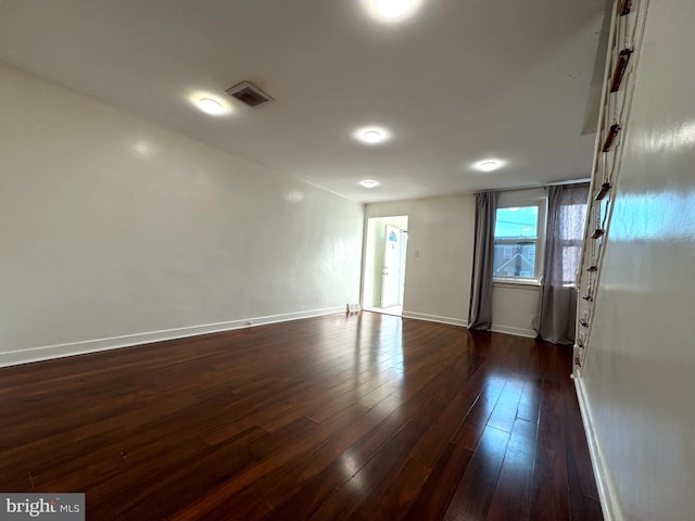 spare room featuring dark hardwood / wood-style floors