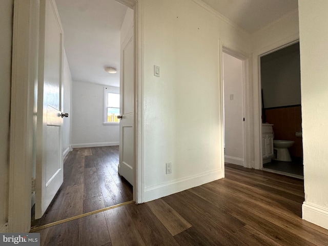 corridor with dark hardwood / wood-style flooring