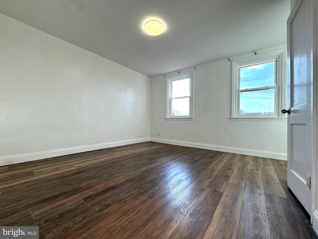 empty room featuring dark wood-type flooring