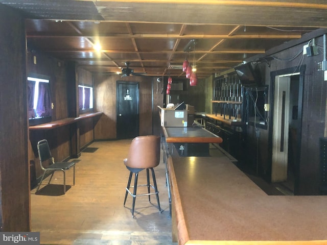 kitchen featuring light wood-type flooring and wood walls