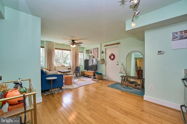 living room featuring ceiling fan and hardwood / wood-style floors