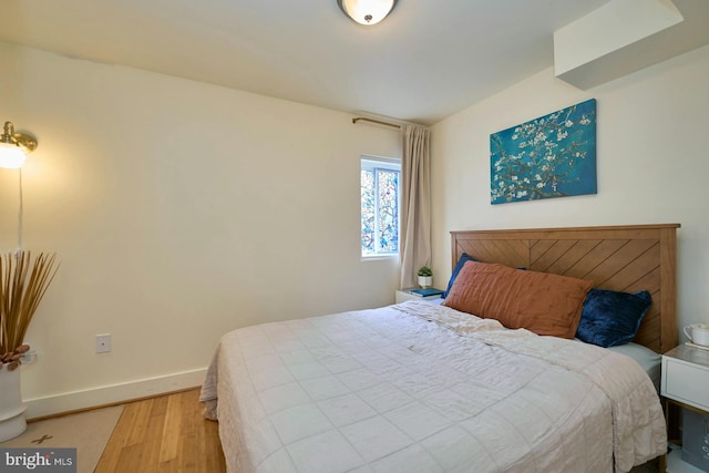 bedroom with wood-type flooring