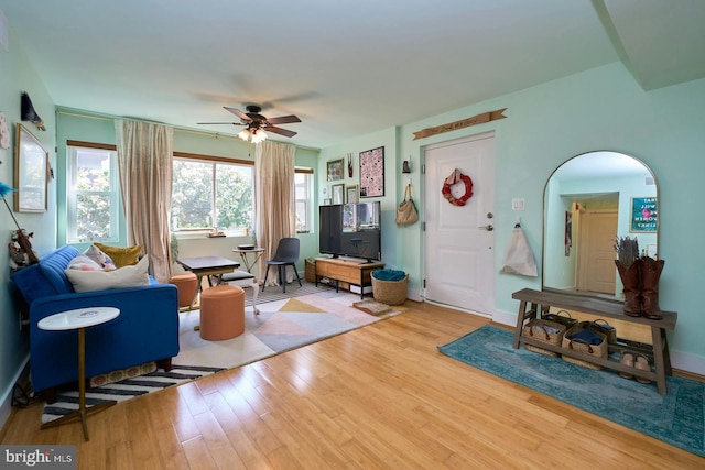 living room featuring light hardwood / wood-style flooring and ceiling fan