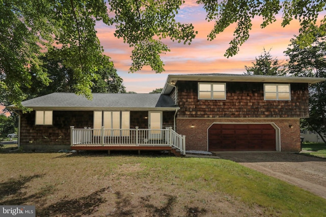 tri-level home featuring a yard and a garage