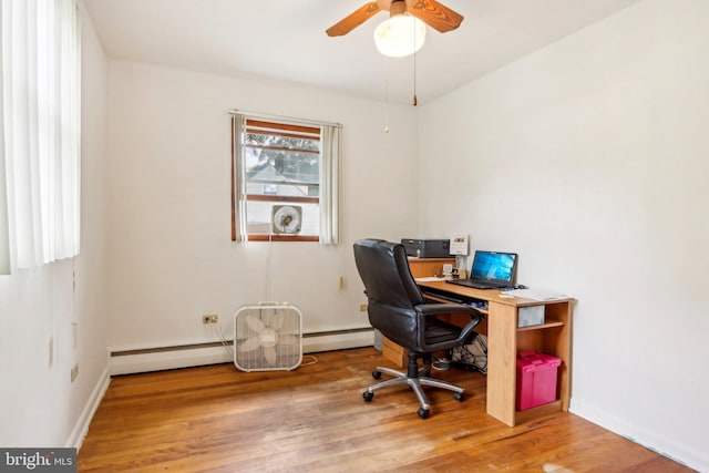 home office featuring baseboard heating, ceiling fan, and hardwood / wood-style flooring