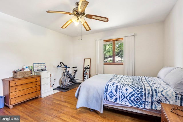 bedroom with hardwood / wood-style floors and ceiling fan