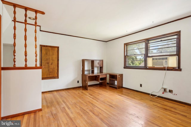 spare room with ornamental molding and light hardwood / wood-style flooring