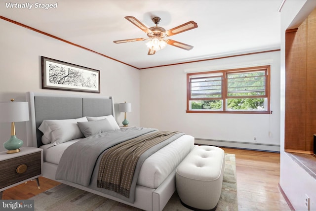 bedroom with a baseboard heating unit, crown molding, ceiling fan, and light hardwood / wood-style floors