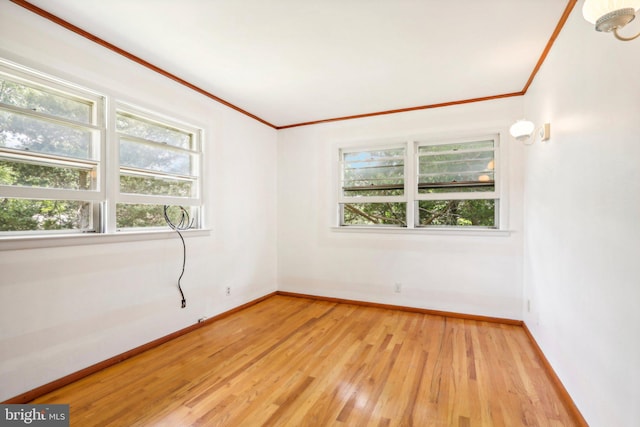 unfurnished room with ornamental molding and light hardwood / wood-style floors