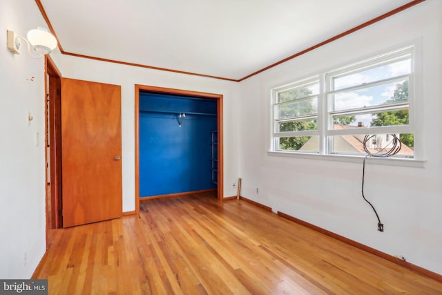 unfurnished bedroom with light wood-type flooring and crown molding