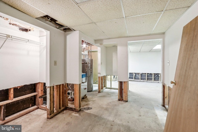 miscellaneous room with a paneled ceiling and concrete floors