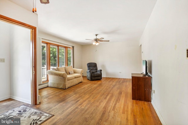 living room featuring ceiling fan and light wood-type flooring