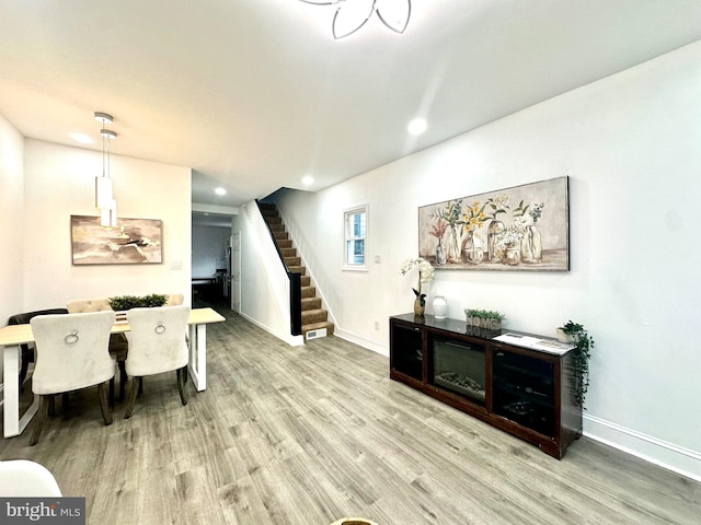 interior space with stairs, light wood finished floors, recessed lighting, and baseboards