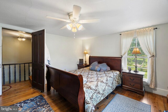 bedroom featuring ceiling fan and dark hardwood / wood-style flooring