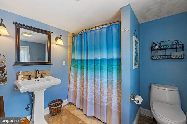 bathroom with toilet and tile patterned floors