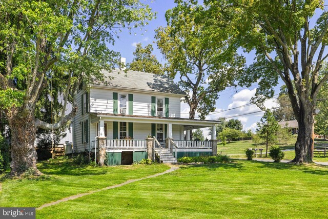 rear view of property with a lawn and covered porch