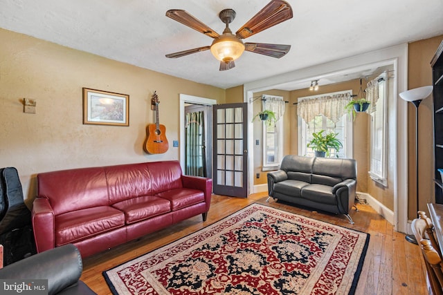 living room featuring ceiling fan and hardwood / wood-style floors