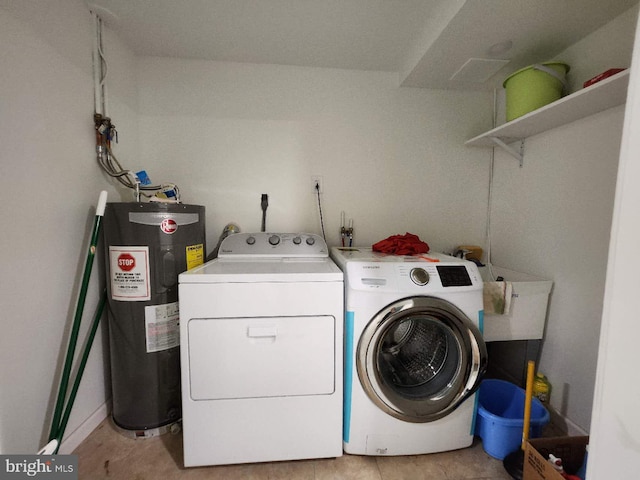 laundry area featuring separate washer and dryer, water heater, and light tile patterned floors