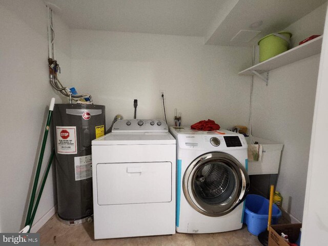 laundry room with laundry area, water heater, and separate washer and dryer