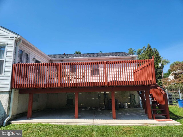 rear view of property featuring central AC, a shingled roof, stairway, a wooden deck, and a patio area