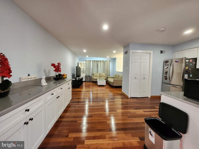 kitchen featuring white cabinets, dark wood finished floors, open floor plan, freestanding refrigerator, and recessed lighting