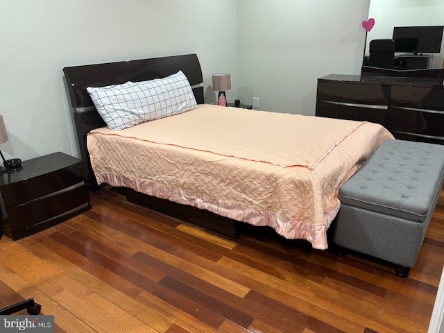 bedroom with hardwood / wood-style floors