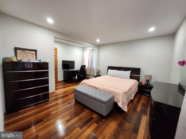 bedroom with recessed lighting and wood finished floors