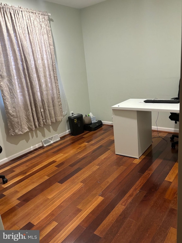 office with dark hardwood / wood-style flooring