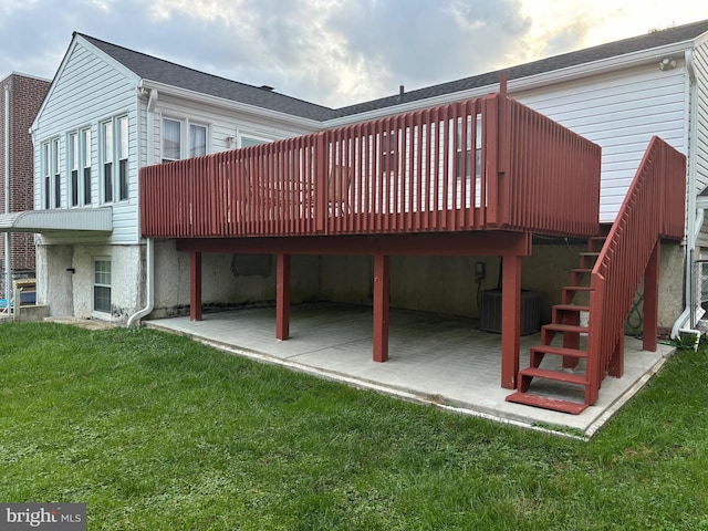 back of house with a deck, a lawn, a patio, and central AC