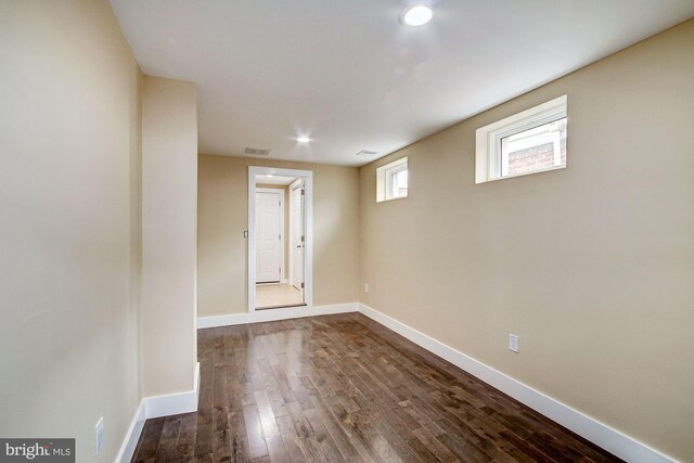 empty room with dark wood-type flooring