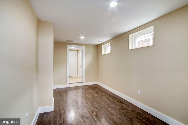 unfurnished room featuring recessed lighting, wood finished floors, visible vents, and baseboards