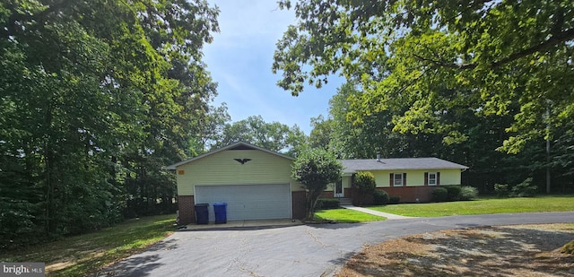 single story home with a front yard and a garage