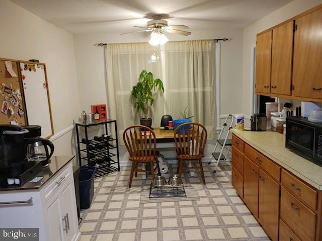 interior space featuring light tile patterned floors and ceiling fan