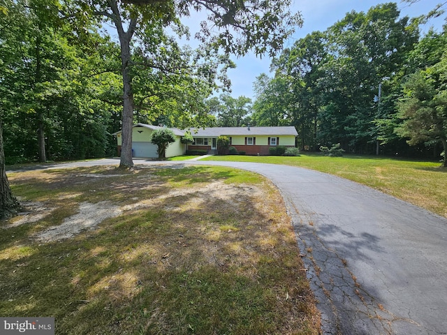 view of front facade with a garage and a front lawn