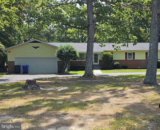 single story home featuring a garage and a front lawn