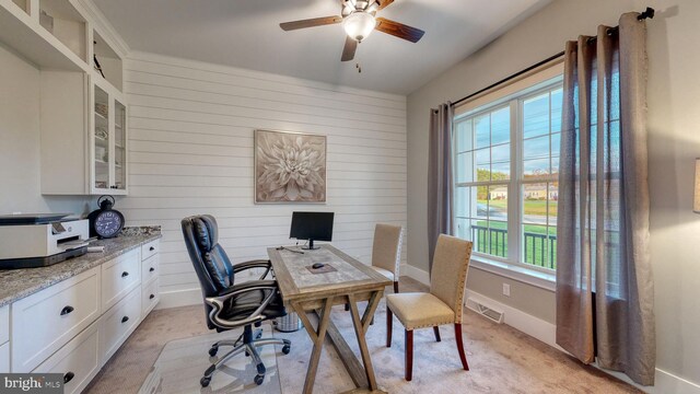 carpeted home office with ceiling fan