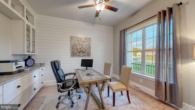 home office featuring baseboards, visible vents, ceiling fan, and light colored carpet