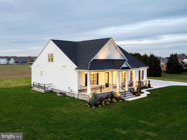 view of front of home with a porch and a front yard