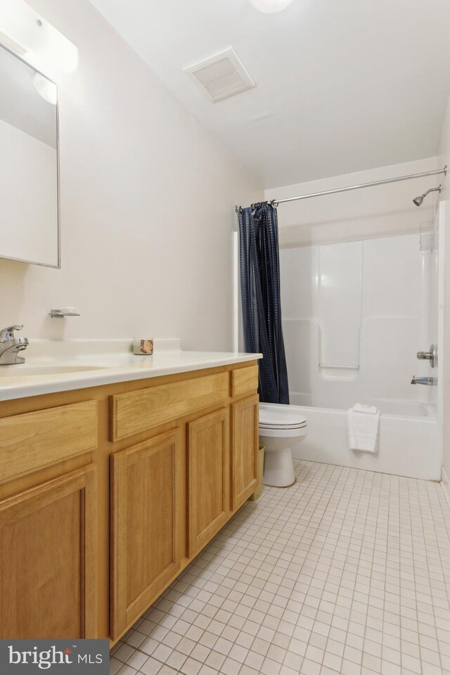 full bathroom featuring vanity, toilet, shower / bath combination with curtain, and tile patterned floors