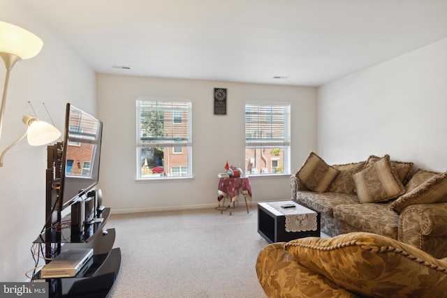 living room featuring carpet flooring and plenty of natural light