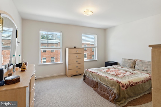 carpeted bedroom featuring multiple windows