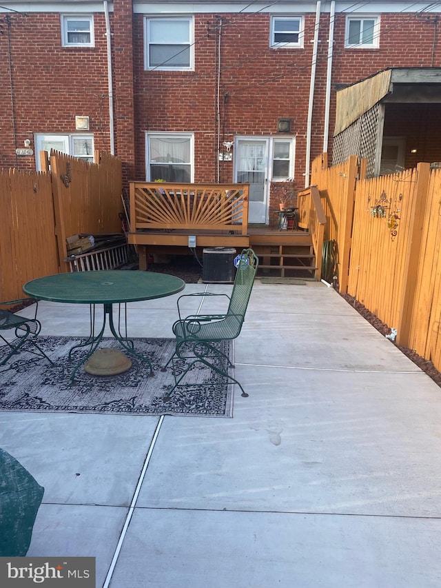 view of patio with a deck and central air condition unit