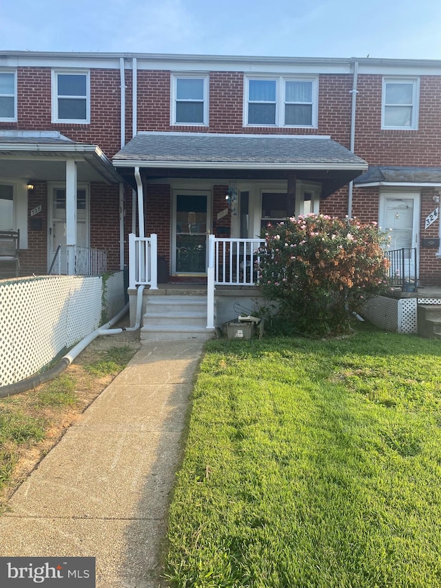 exterior space with a porch and a front lawn